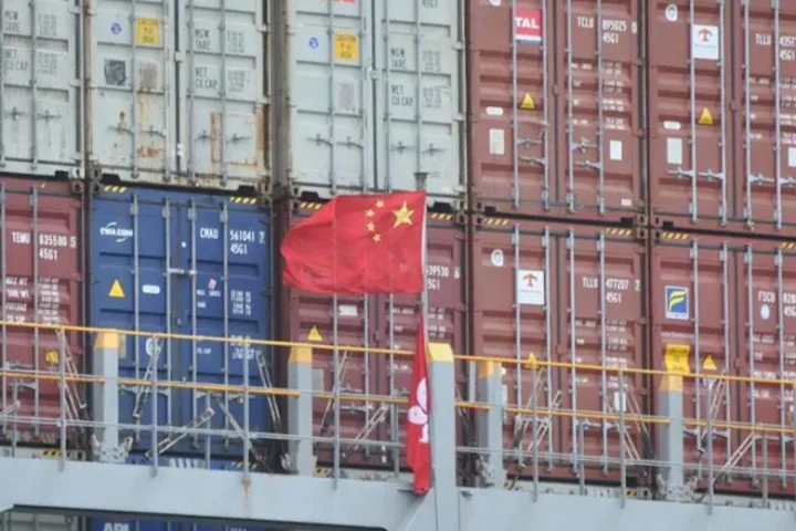 Infographic showing a downward arrow over a shipping container, labeled "935 Items" and "China Import Tariffs 2026."